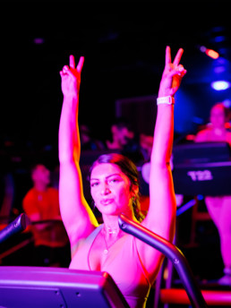 BMF member working out at the thread with her hands raised up in the air!